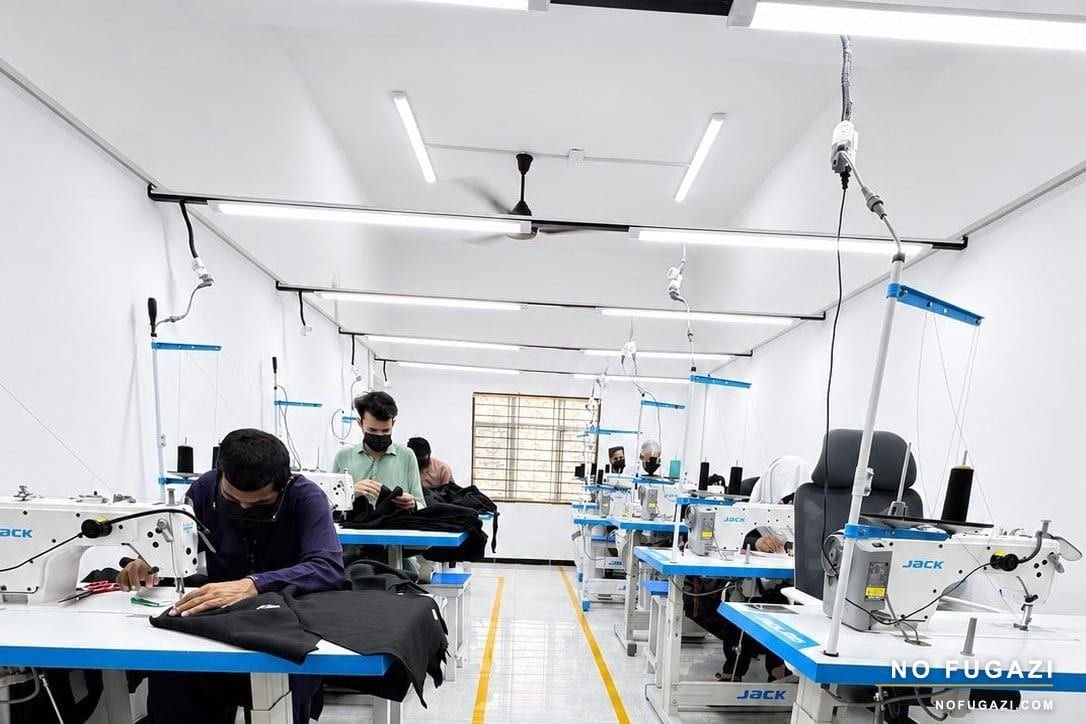 Machinists sewing custom garments on the NO FUGAZI production line